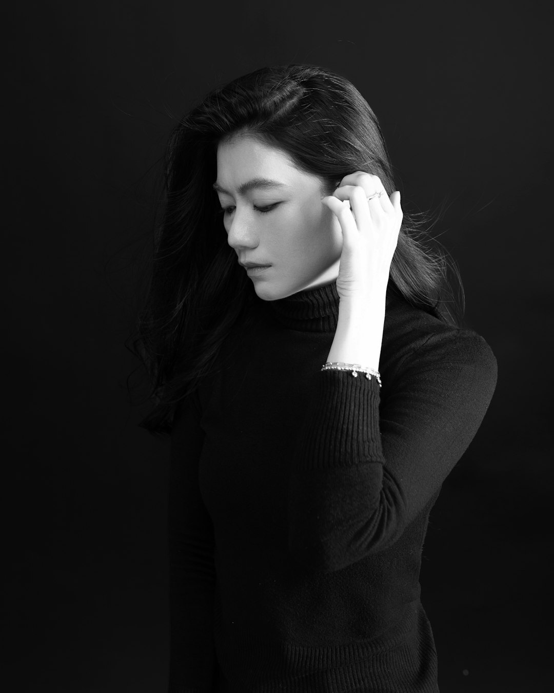 Studio portrait of a young woman with dark hair in business casual attire