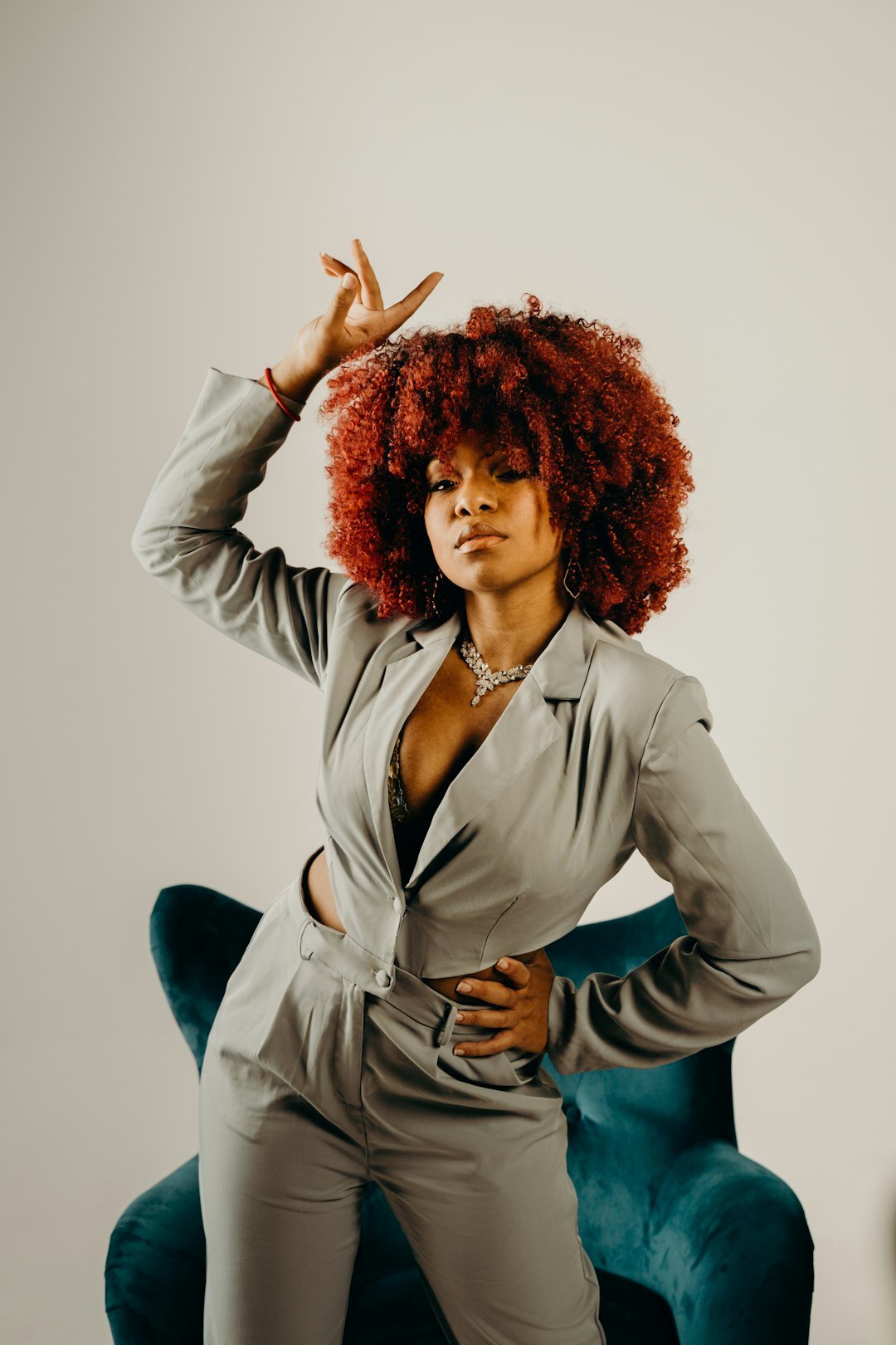 Studio portrait of a woman with curly hair wearing tailored business attire