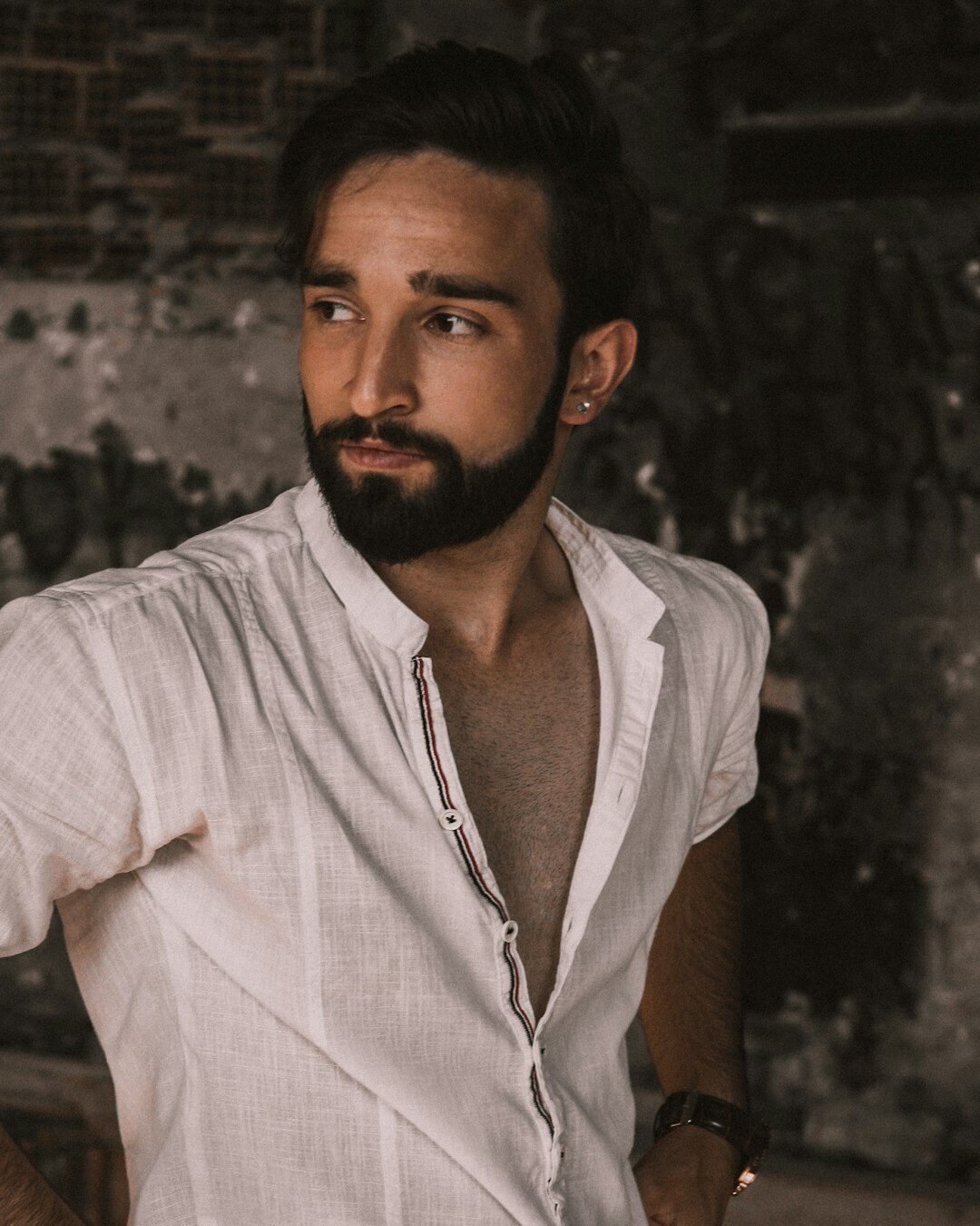 Studio portrait of a man with short beard in a linen shirt