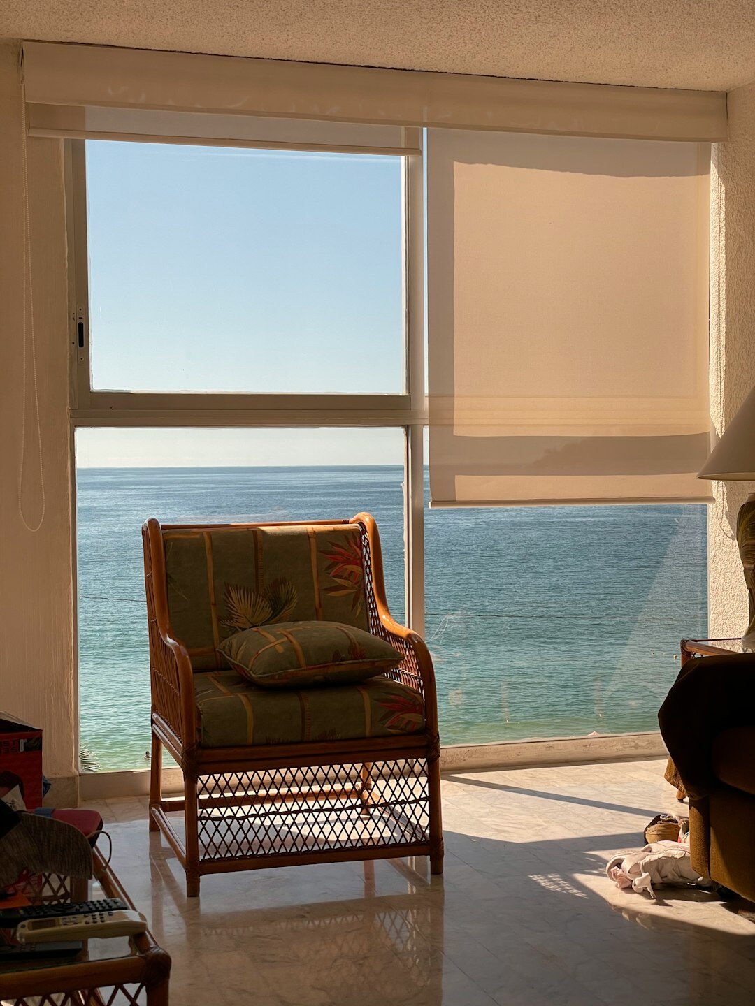 Open-plan living room with floor-to-ceiling windows overlooking the ocean