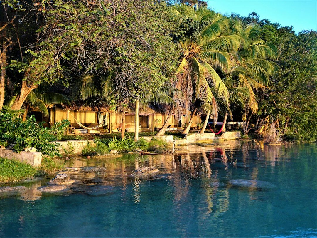 Boutique beach houses along a quiet lagoon at sunset