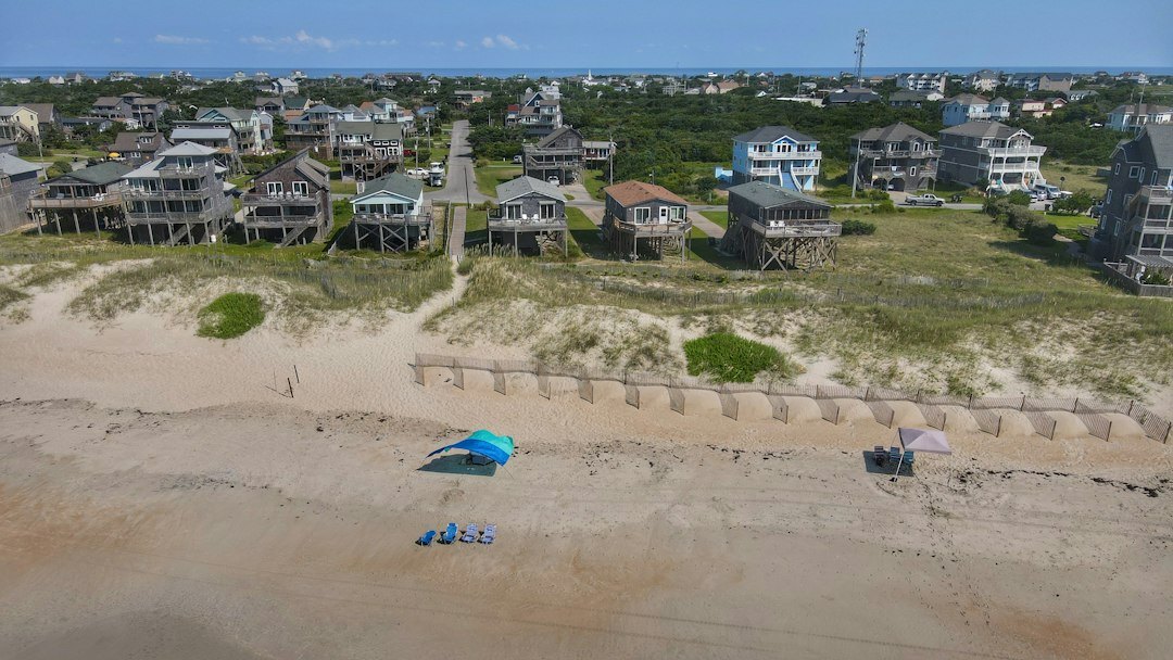 Sand dunes and beach houses along a wide Atlantic beach
